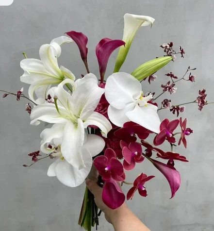 White lilies and wine-colored orchids in the Brianna bouquet